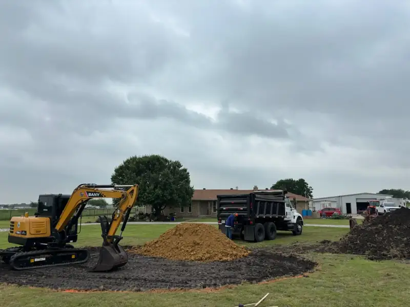 SANY excavator and dump truck prepping the yard art display site