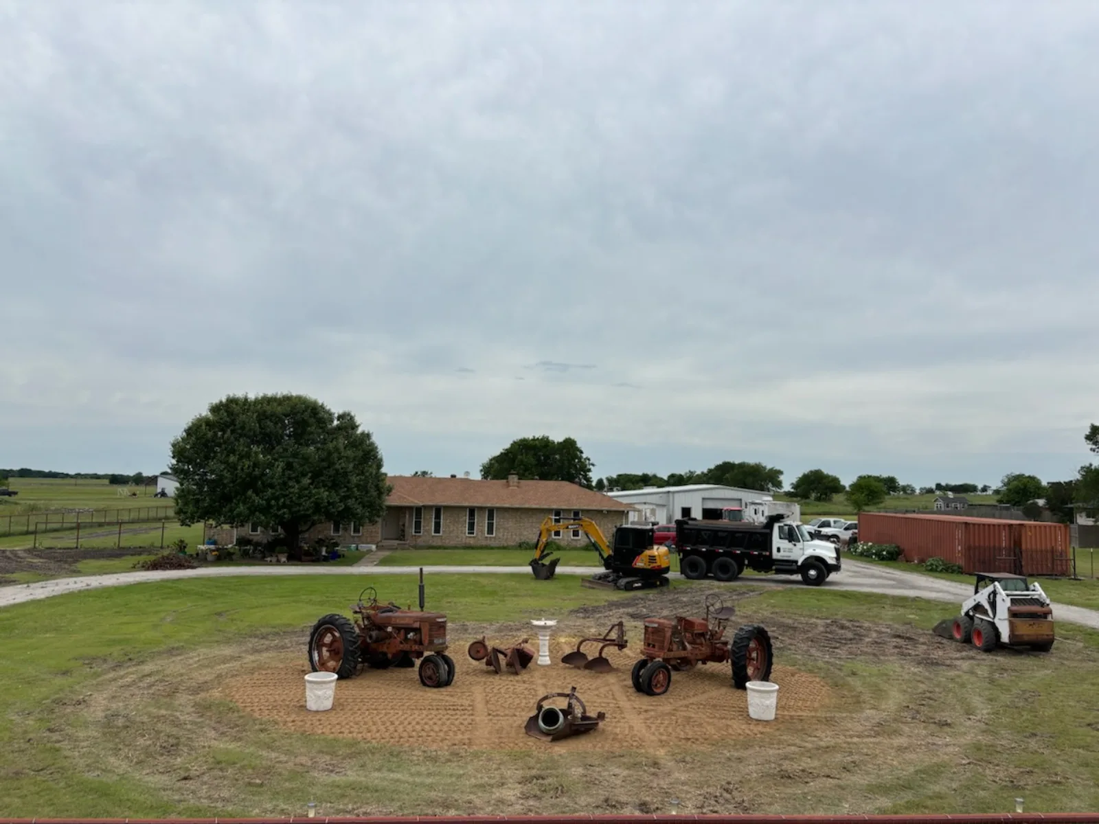 The Scott Ranch yard with tractors, dump trucks, excavator and skid steer
