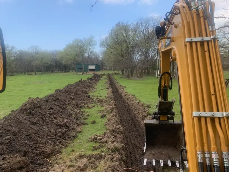 Long water line trench cut across a North Texas pasture
